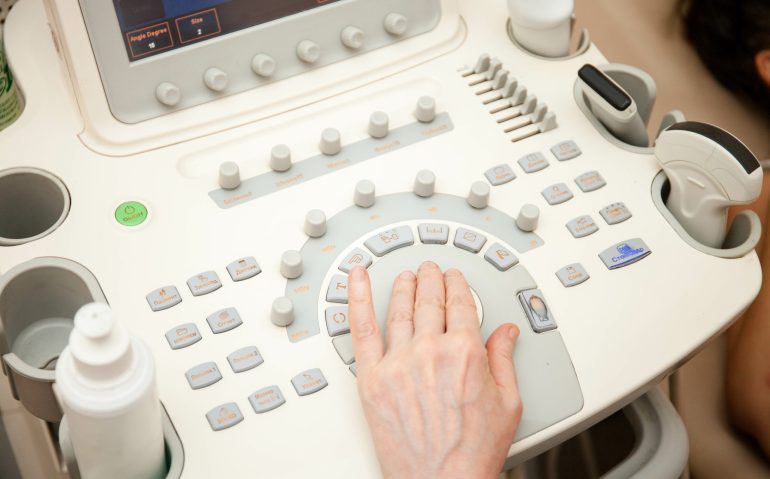 Doctor performing an ultrasound examination on specialized equipment